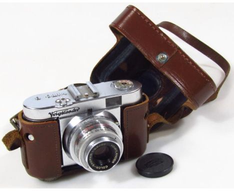 A Voigtlander camera with Dallmeyer London lens cap, and Color-Skopar 1:3.5/50 lens, 9cm high, in brown leather case.