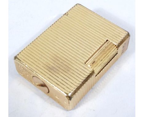 A 20thC Dupont gold plated lighter, of engine turned outline with hinged lid and rounded corners, 5cm wide. (in associated bo