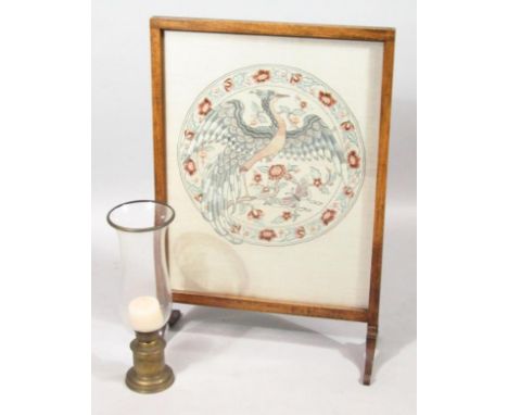 An Edwardian oak fire screen, with central embroidered bird and floral panel, on scroll supports, 90cm high, 60cm wide, 26cm 