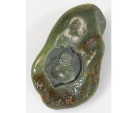 A 20thC Chinese green jade style carving, centred by Buddha with a shaped outline, unmarked, 8cm wide.