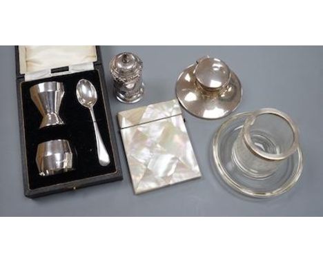 A 1930's cased silver christening trio, a silver mounted inkwell, a silver pepperette, a silver mounted glass match strike/as