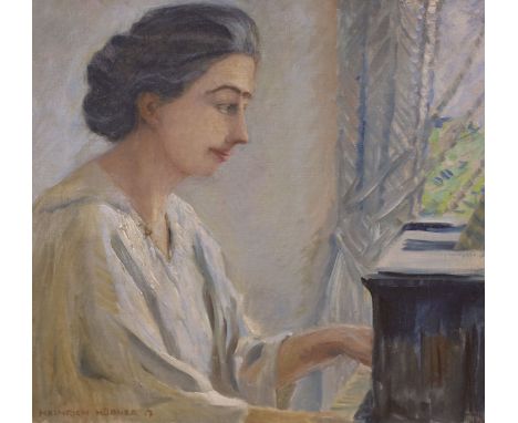 Heinrich Hübner (German, 1869-1945), oil on canvas, Lady playing the piano, signed and dated '17, 42 x 46cm