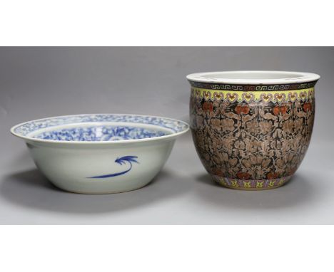 A 19th century Chinese blue and white basin and a famille rose jardiniere. Basin 29cm diameter