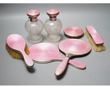 A George silver and enamel mounted glass part dressing table set, by Henry Clifford Davis and a similar American hand mirror.