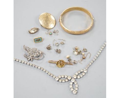A 9ct gold hinged bangle, 17.4 grams, an engraved yellow metal locket, a 9ct and gem set bar brooch, gross 3.3 grams, a Victo