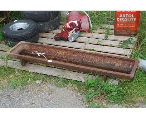 A cast pig trough, 47 1/2'' long x 10 1/2'' wide.