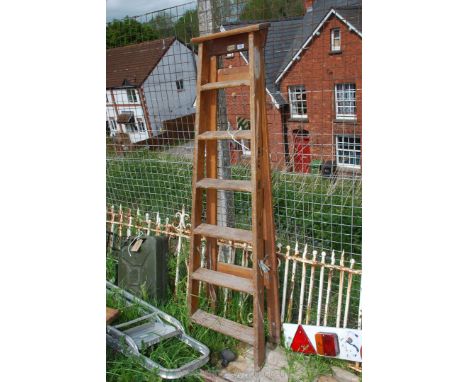 A six ring wooden step ladder.
