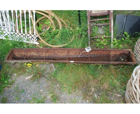 A cast iron trough, 70'' long.