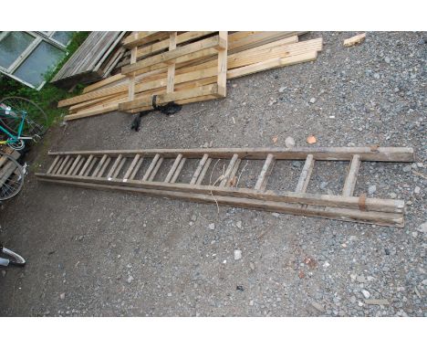 A fourteen rung double wooden ladder.