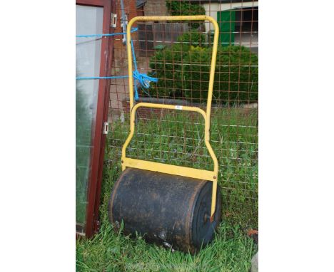 A metal garden roller.