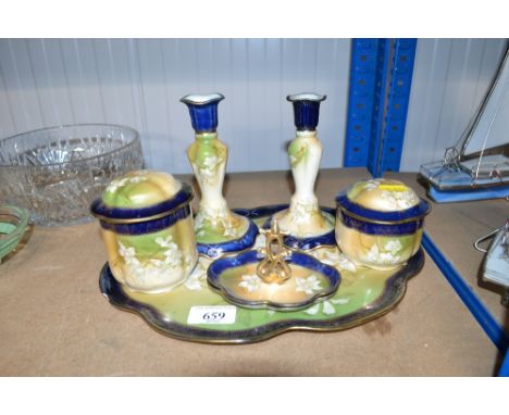 A collection of porcelain floral decorated dressing table items to include a tray; candle sticks; ring tree etc