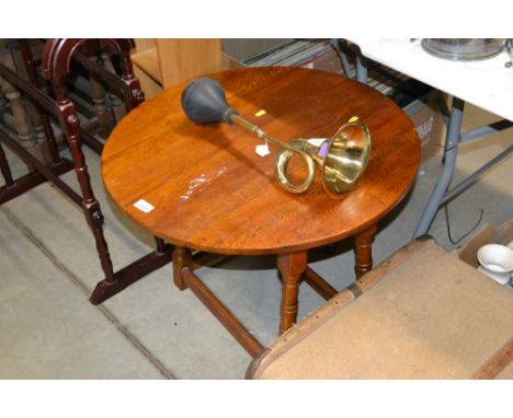 A circular oak occasional table and a narrow oak shelf