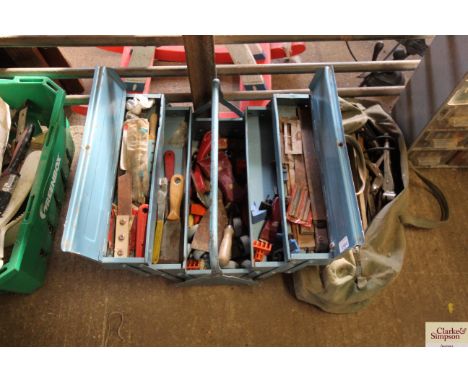 A metal cantilever toolbox containing a small selection of tools, a holdall of various vintage tools