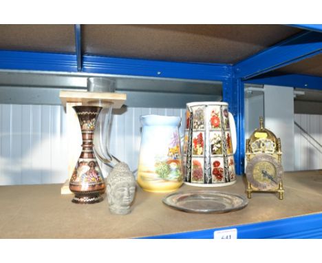 A brass battery operated lantern style clock; a glass vessel on wooden stand; a Buddha's head; silver plated dish and two dec