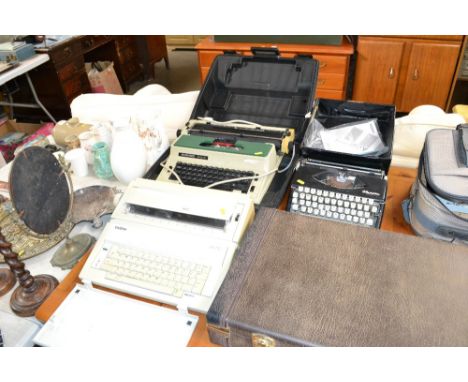 An Olympia Splendid 66 typewriter; a Silver Reed work processor and a Brother word processor