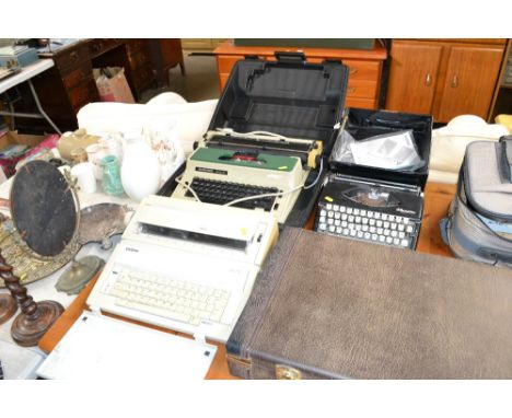 An Olympia Splendid 66 typewriter; a Silver Reed work processor and a Brother word processor