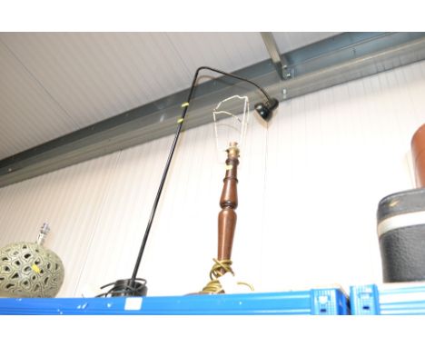 A turned wooden standard lamp and an adjustable lamp