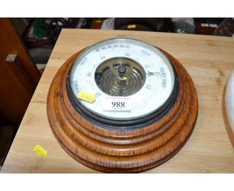 A circular oak cased barometer