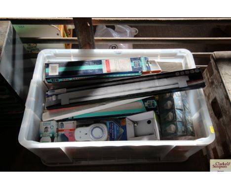 A plastic box of various strip lights, electric timer plugs, light bulbs etc.