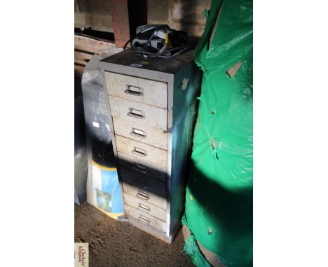 A metal nine drawer cabinet with a quantity of tools to include files; screws; fixings; chisels and some bolsters 