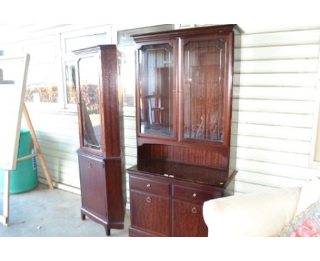 A Stagg display cabinet raised on cupboard base and a Stagg upright glazed corner cabinet