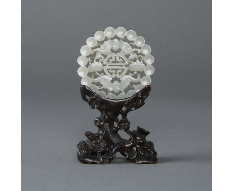 A stunning Chinese jade carving on what is likely its original hardwood stand. Both the jade and dark hardwood stand are of t