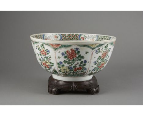 A striking Chinese famille verte punch bowl with lovely enamels in greens and reds of flowers and insects. Retains its early 