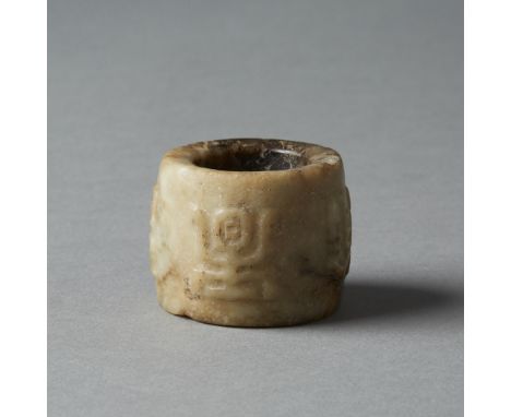 A hand carved archers ring of a hard stone, likely not jade. Dimensions: 1 in. x 1 2/8th in., Weight: 30.3gCondition:Wear thr