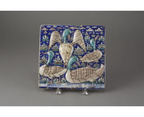 An excellent tile decorated with ducks in a pond in the foreground and mountains in the background. Dimensions: 10 in. x 10.5