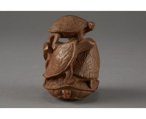 Well carved netsuke depicting a group of turtles climbing over one another. Excellent condition. Signed in a reserve on the b