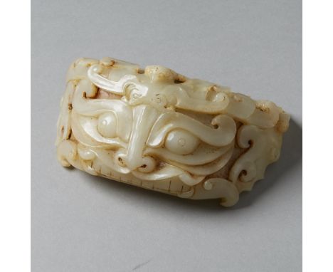 A massive jade carving in the form of an archaic fitting perhaps for a throne or chariot. Very unusual taotie mask motif rare