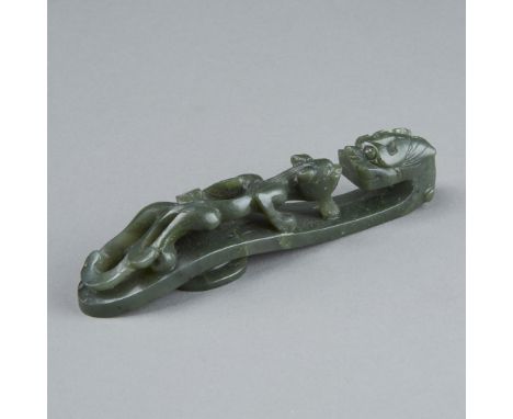 An excellent example of a dragon belt hook carved from very fine spinach jade. Dimensions: 5 in. x 1 in., 1 6/8th x 1 2/8th, 