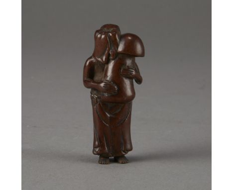A wonderful netsuke carved into the form of a woman with her head upturned, while holding a massive and rather phallic mushro