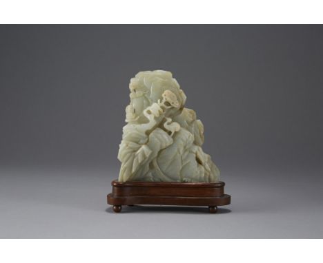 An exceptional light celadon or white jade carving of a mountain with cranes and deer among the rocks. The animals appear to 