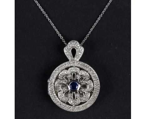 A sapphire and diamond locket pendant, the circular floral openwork front set a round mixed cut sapphire, closed back, to a 1