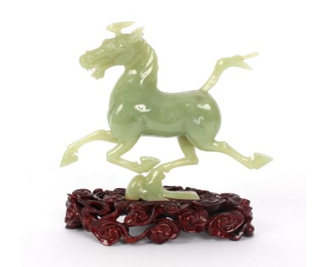 A jade carving of a galloping horse, on a stand, 14cm high
