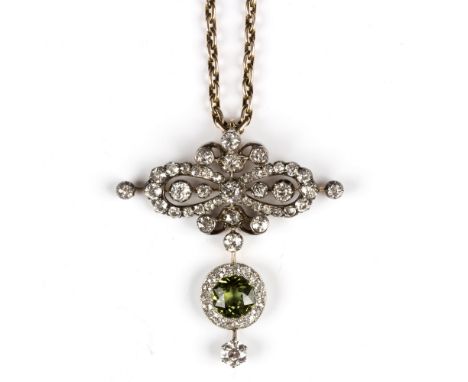 A Victorian green sapphire and diamond pendant of bow form, suspending a circular green sapphire and diamond cluster, on a ye