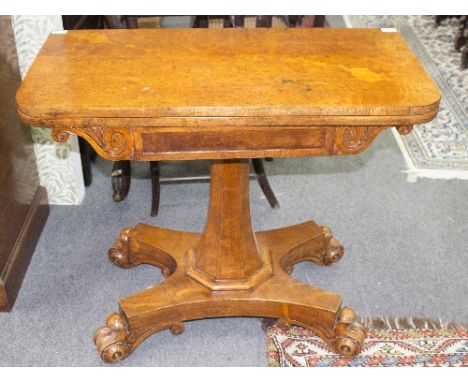 A William IV burr elm card table, the frieze with carved bracket to the sides, on a hexagonal tapered column and flat quadrup