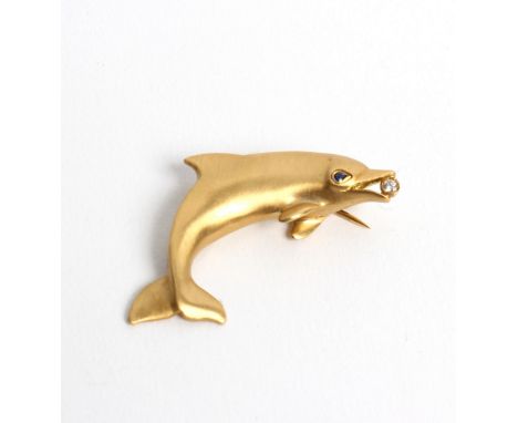 An 18ct gold dolphin brooch by Tiffany & Co, the dolphin with sapphire eye and diamond in its mouth, 4cm long approximately 6