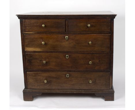 An 18th Century oak chest of two short over three long drawers, with brass knob handles and escutcheons, on bracket feet, 97c