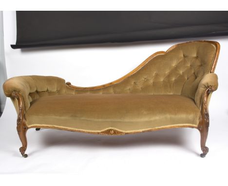 A Victorian walnut single chair back settee with deep button back and carved scroll arms, on cabriole legs, 183cm wide