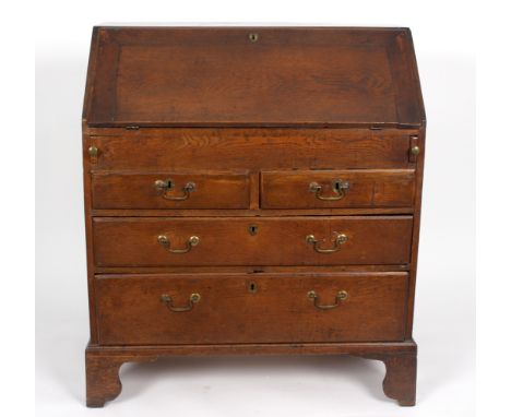 A George III oak bureau, the fall enclosing a fitted interior, above two short and two long drawers, on bracket feet, 90cm wi
