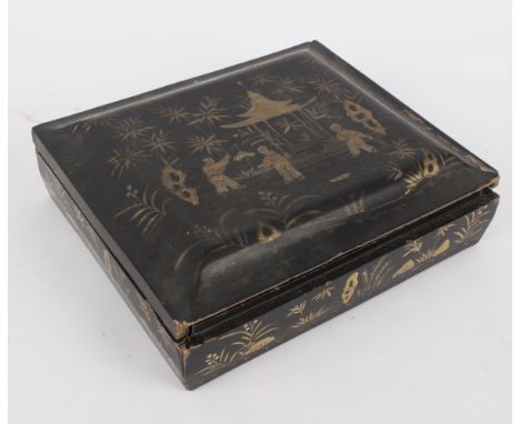 A Chinese export lacquer gaming token box, damages, the cover decorated boys playing by a pagoda, fitted with lidded boxes an