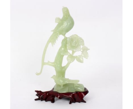 A jade carving of birds in flowering branches, on a stand, 23cm high