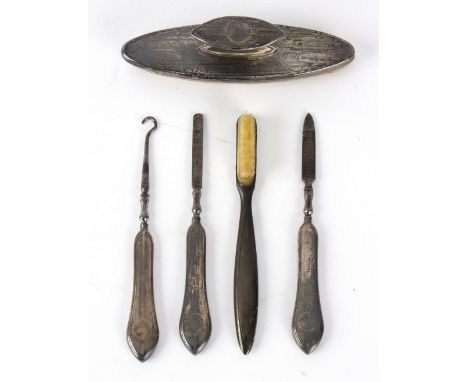 A small group of silver including nail buffer, nail file, toothbrush and button hook/Provenance: from the attic of a Welsh co