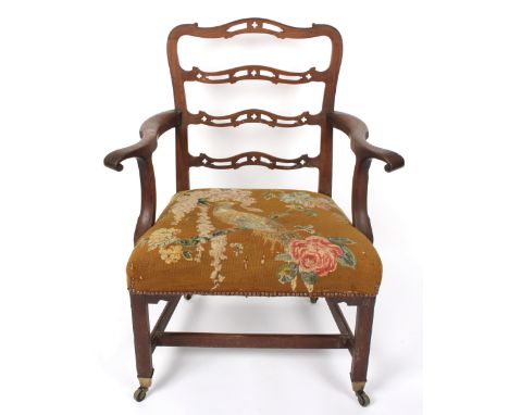 A George III ladder back open armchair, with needlework seat on square legs with castors