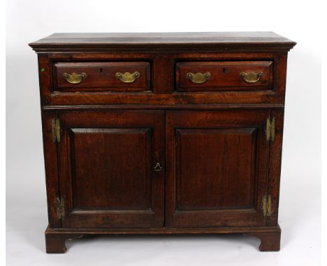 A Georgian oak side cabinet, fitted two drawers above cupboard doors, on bracket feet, 110cm wide Condition Report: Top repla