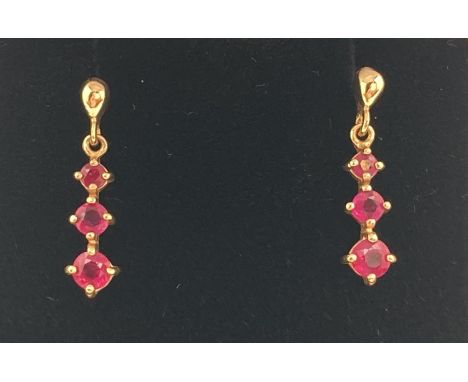 A pair of 9ct yellow gold ruby set drop earrings, fully hallmarked to posts. Complete with butterfly backs. Drops set with 3 