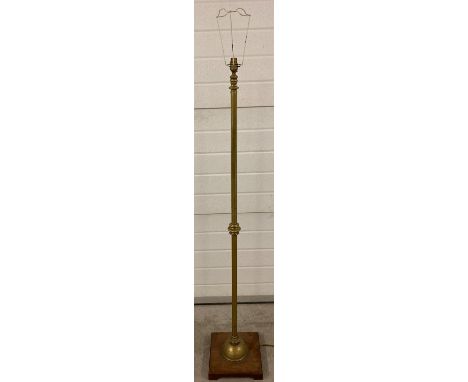 A vintage brass standard lamp mounted on a wooden square shaped base. Approx. 147cm tall. 