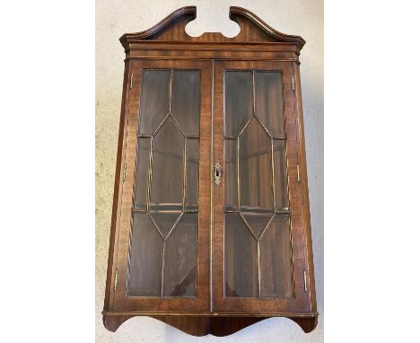 A vintage mahogany wall hanging corner cupboard with glazed panelled doors. Complete with 2 interior shelves and key. Approx.